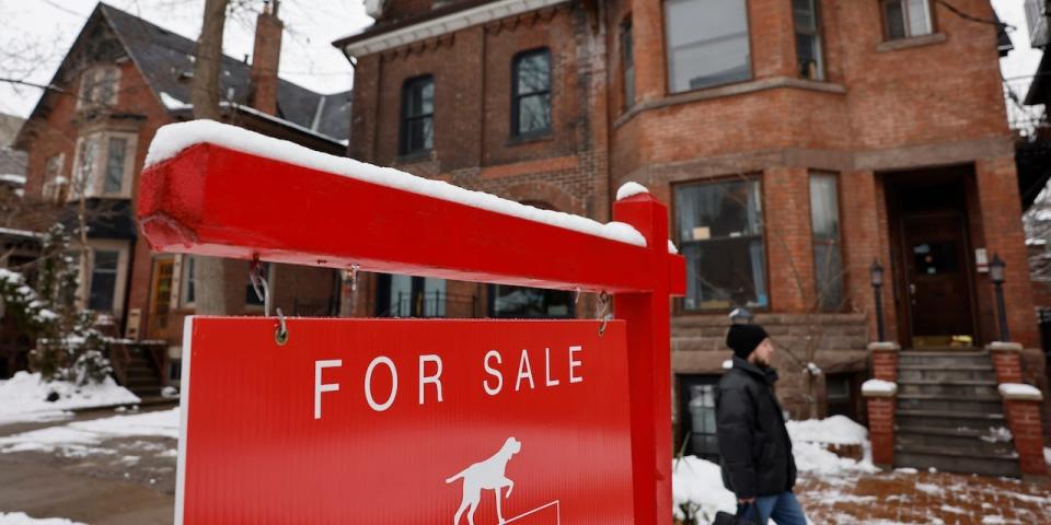 A FOR SALE sign is displayed outside a property on Madison Ave. in Toronto.