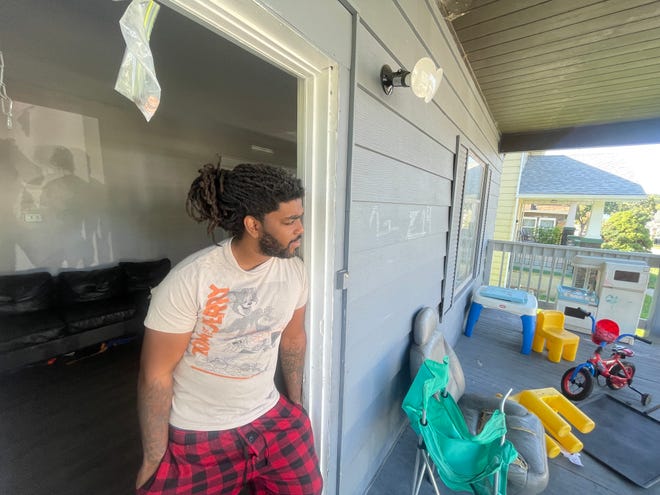 Aaron Smith stands in the doorway of his family's former rental home at 214 E. Irvington Ave. in South Bend. The family was evicted this November after finding out they'd fallen victim to a rental scam and had paid $1,600 to a fraudulent landlord.