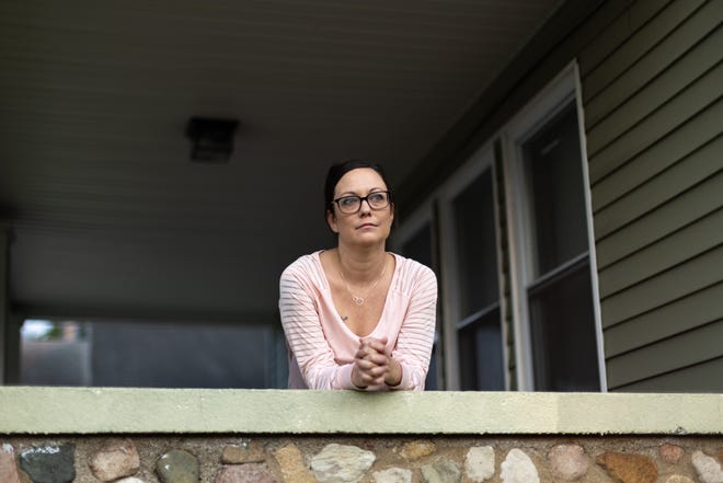 Amy Hadley stands on the porch of her home in the 1800 block of East Calvert Street in South Bend. Hadley seeks compensation for damages inflicted by local police departments after her home was mistakenly raided in June 2022.