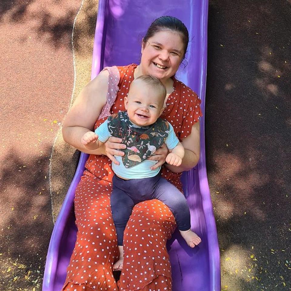 Image of Nataasha with her son on a slide - money 