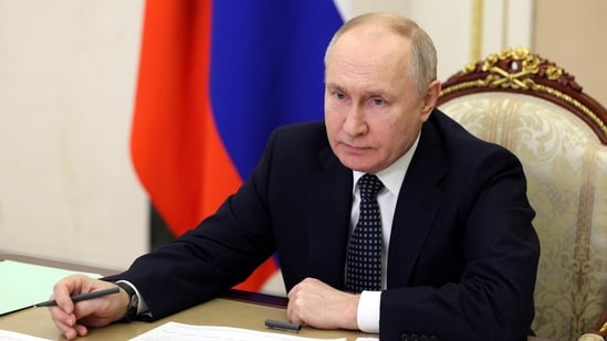 Russian president Vladimir Putin chairs a meeting.(AFP)
