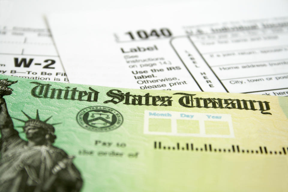 Tax Refund Check with W-2 and 1040 U.S. Individual Income Tax Return Forms