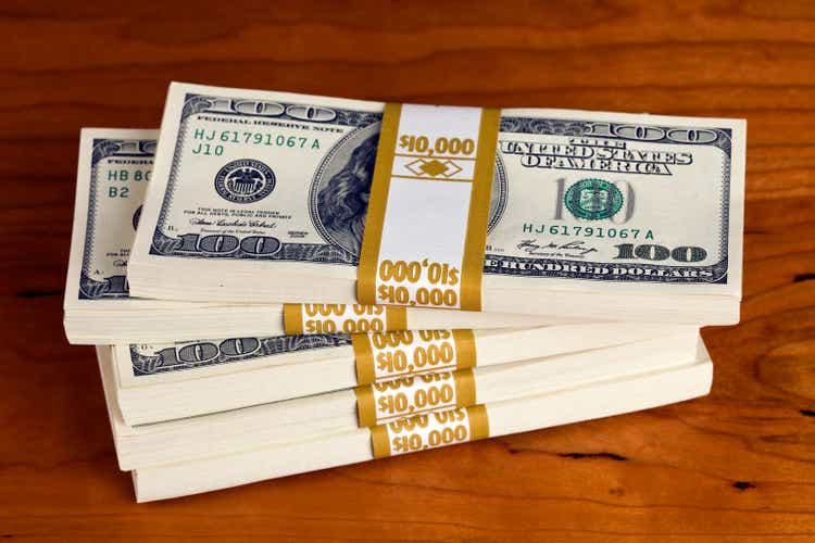 $50,000 in US $100 Bills on a Cherry Desk