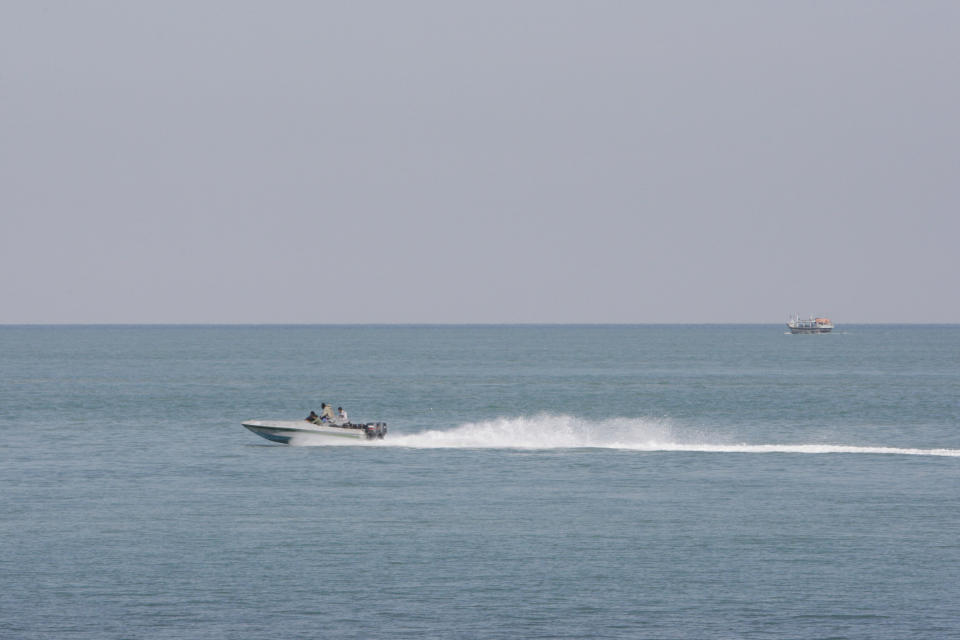 An Iranian police boat patrols near the island of Qeshm, which oversees strategic the waterway of the Strait of Hormuz, Iran, on Saturday, Dec. 24, 2011. (AP Photo/Vahid Salemi)