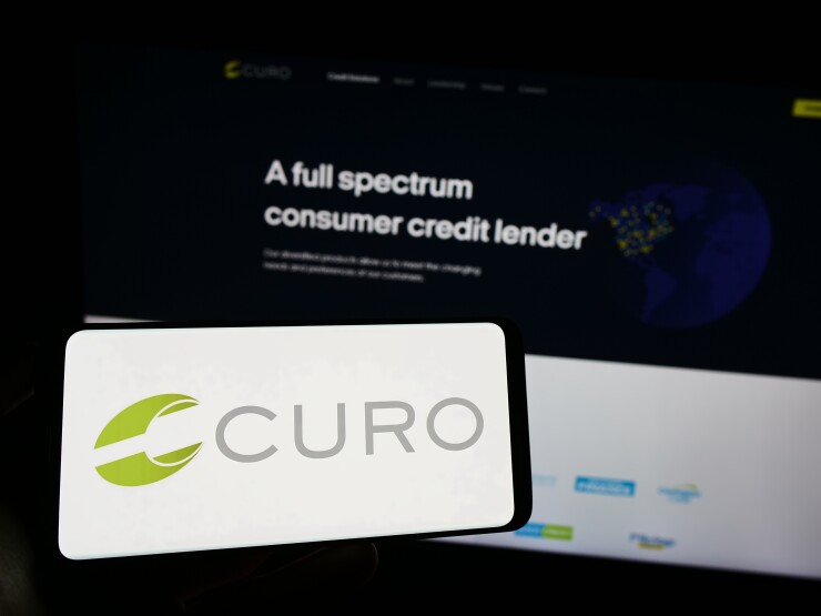 Logo of US financial company CURO Group Holdings Corp. on screen in front of web page