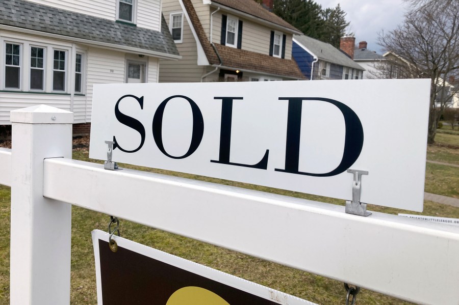 FILE - A sold sign hangs in front of a Brighton, New York house on Tuesday, February 21, 2023. The average rate on a 30-year mortgage rose to 6.66% from 6.62% last week, mortgage buyer Freddie Mac said Thursday, Jan. 11, 2024. (AP Photo/Ted Shaffrey, File)