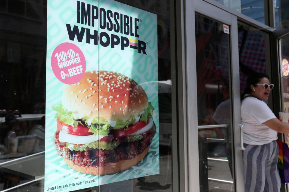 FILE PHOTO: A sign advertising the soy based Impossible Whopper is seen outside a Burger King in New York, U.S., August 8, 2019. REUTERS/Shannon Stapleton/File Photo