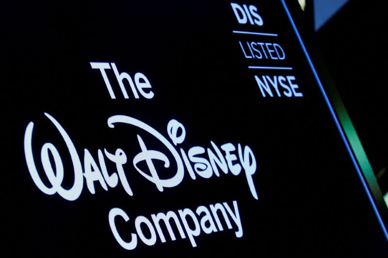 A screen shows the logo and a ticker symbol for The Walt Disney Company.