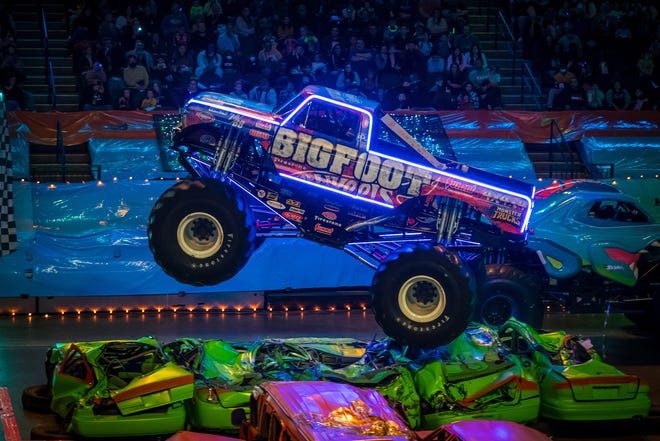 Families get the chance to see real-life versions of the famous Hot Wheels monster truck toys do battle in the dark.