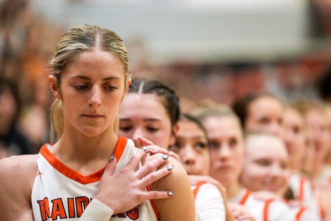 Ryle Raiders forward Quinn Eubank (0), left, during the national anthem before the first half of the high school girls basketball game between neighborhood rivals Cooper Jaguars and Ryle Raiders on Friday, Jan. 12, 2024, at Ryle High School in Union, Ky. Cooper won 38-32.