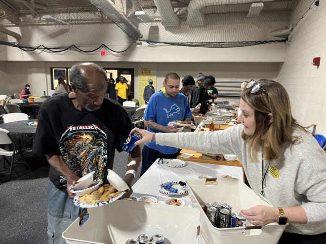 Volunteers serve food to residents of the Neighborhood Service Organization Bell Building in Detroit, as volunteers gear up for Point-in-Time Count, Wednesday, Jan. 31, 2024.