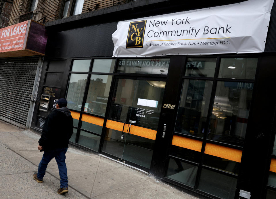 FILE PHOTO: A man walks past a closed branch of the New York Community Bank in New York City, U.S., January 31, 2024. REUTERS/Mike Segar/File Photo