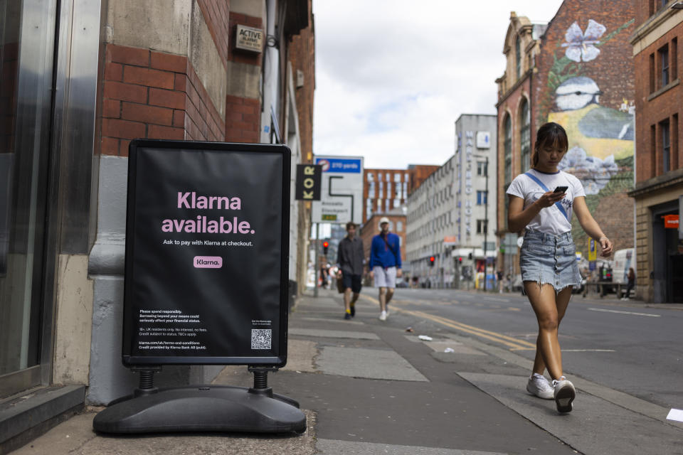 Members of the public pass by a floor advertisement for tech firm Klarna, which allows users to buy now, pay later, or pay in instalments. (Credit: Daniel Harvey Gonzalez/In Pictures via Getty Images)