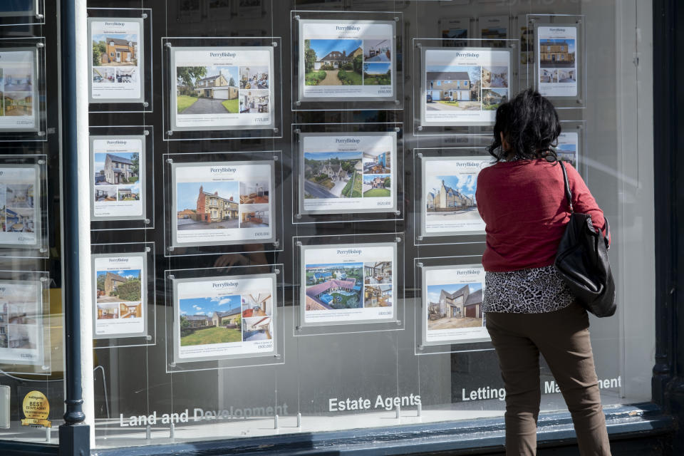 People looking at houses for sale in an estate agents window. (Credit: Mike Kemp/In Pictures via Getty Images)