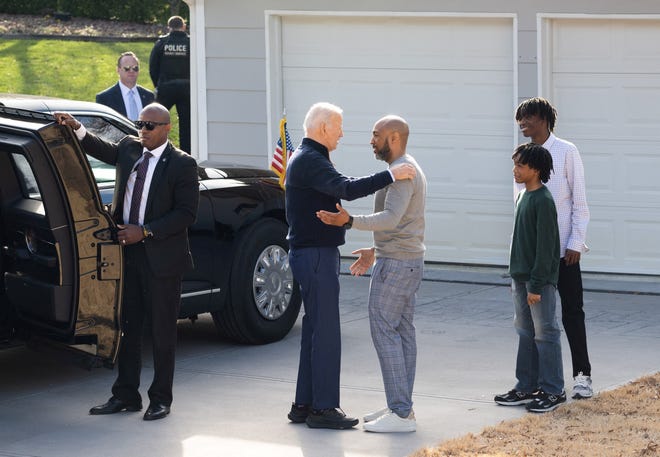 President Joe Biden greets a family for a conversation about student loan debt forgiveness at their home in Raleigh, N.C., Jan. 18 after he touted his economic agenda in a speech at Abbotts Creek Community Center.