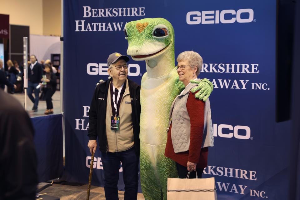 OMAHA, NEBRASKA - APRIL 30: Shareholders pose for a picture with a Geico mascot at the Berkshire Hathaway annual shareholder's meeting on April 30, 2022 in Omaha, Nebraska. This is the first time the annual shareholders event has been held since 2019 due to the COVID-19 pandemic. (Photo by Scott Olson/Getty Images)