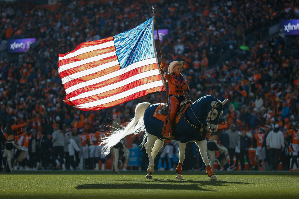 Nov 26, 2023; Denver, Colorado, USA; Denver Broncos mascot Thunder ridden by Ann Judge crosses the field with the American Flag after a touchdown in the first quarter against the Cleveland Browns at Empower Field at Mile High. Mandatory Credit: Isaiah J. Downing-USA TODAY Sports