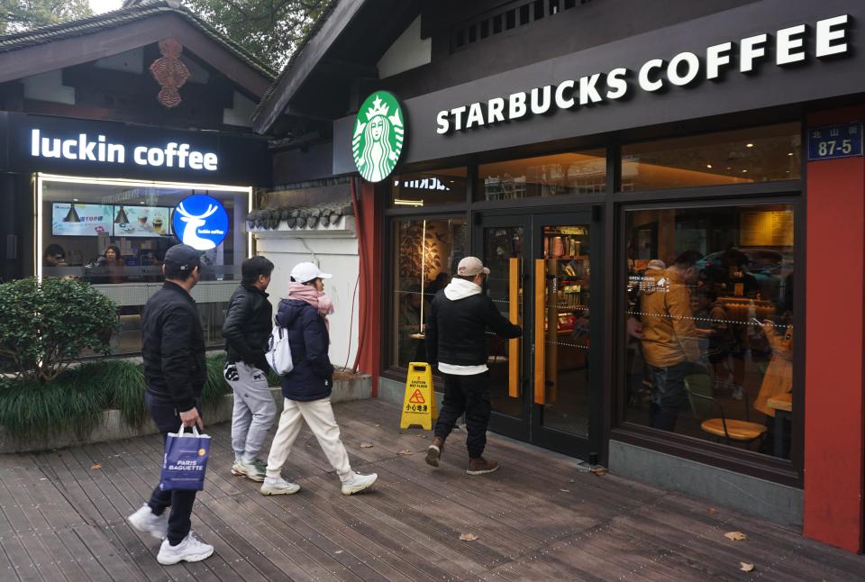 HANGZHOU, CHINA - FEBRUARY 25, 2024 - Photo taken on Feb 25, 2024 shows a nearby Luckin Coffee and Starbucks store in Hangzhou, East China's Zhejiang province. Recently, Luckin Coffee announced 2023 annual financial report, Luckin Coffee 2023 total net income of 24.903 billion yuan (about 3.46 billion US dollars), an increase of 87.3%, in the annual sales scale for the first time exceeded Starbucks China 22.739 billion yuan (3.16 billion US dollars). Thus becoming the largest coffee chain in the Chinese market. (Photo credit should read CFOTO/Future Publishing via Getty Images)
