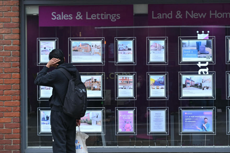 A member of the public looks at houses for sale in the window of an Estate Agents in March 7, 2024.  (Credit: Justin Tallis, AFP via Getty Images)