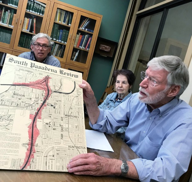 Freeway Fighter Glen Duncan holds up a blow up of an old newspaper showing the areas to be taken by a surface route 710 Freeway extension through South Pasadena at the South Pasadena Public Library on Tuesday, June 11, 2019. (photo by Steve Scauzillo, SCNG)