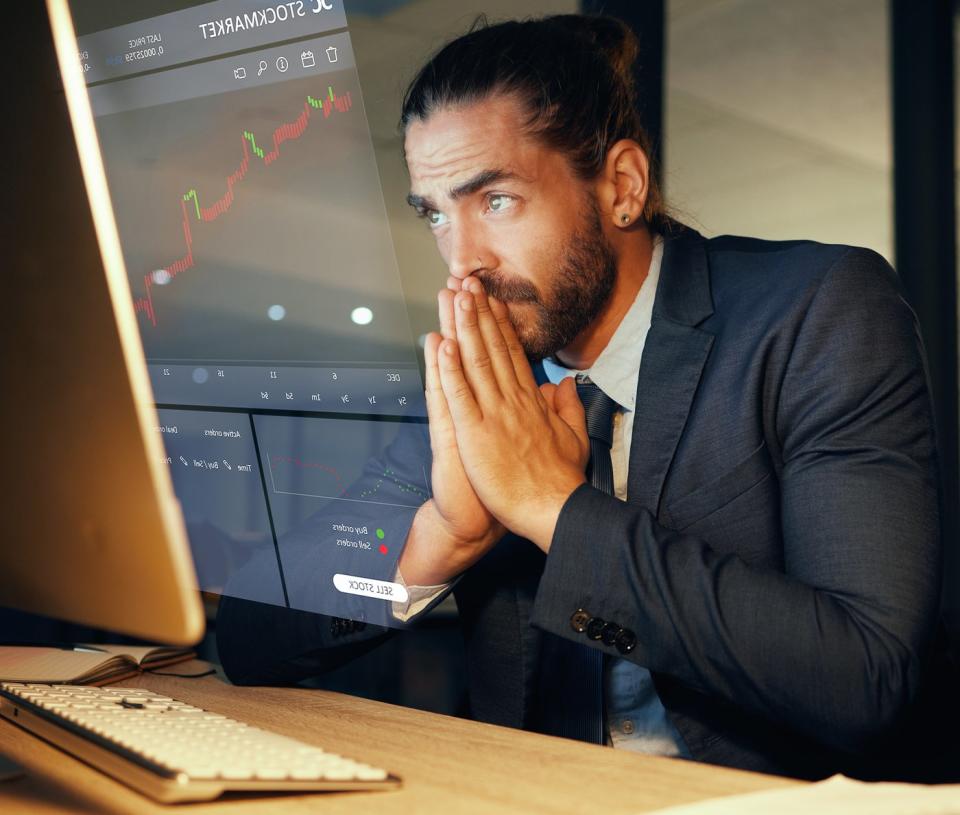 anxious man looking at his stock charts on a computer