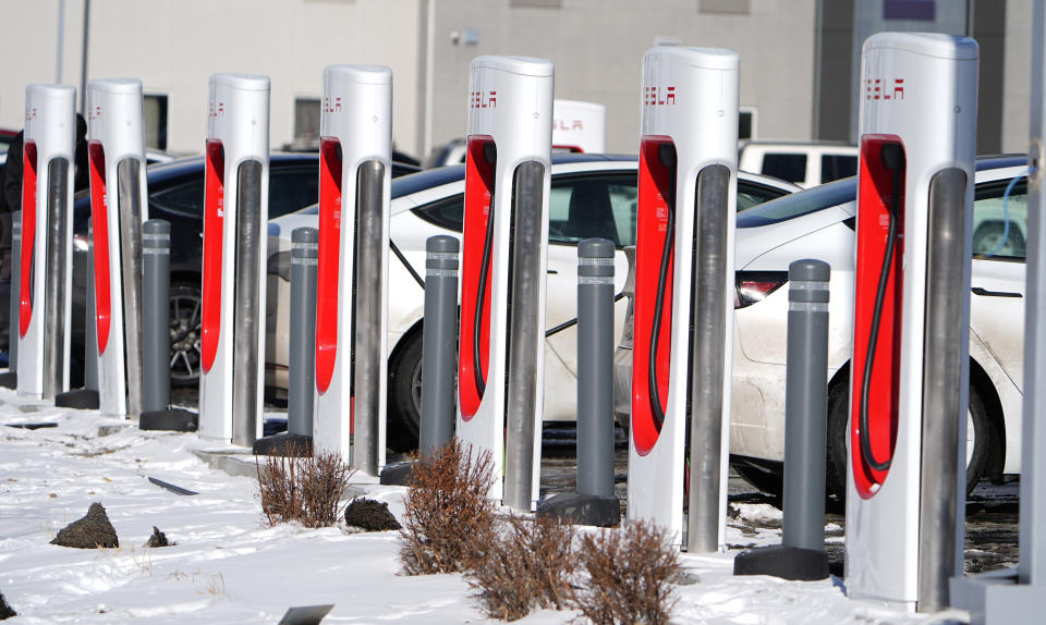 FILE - Motorists recharge their Tesla vehicles at a Tesla supercharging location, Jan. 16, 2024, in northeast Denver. Wisconsin Gov. Tony Evers signed bipartisan bills Wednesday, March 20, 2024 designed to jump-start creation of an electric vehicle charging network along Wisconsin's interstate system and major highways. (AP Photo/David Zalubowski, file)