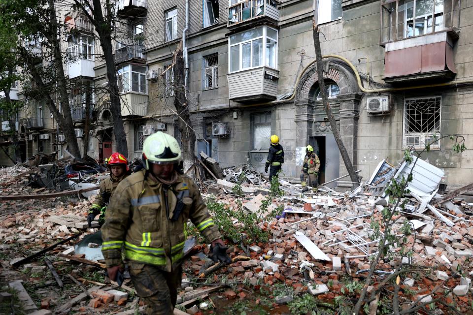 TOPSHOT - Ukrainian rescuers work in the courtyard of a residential building damaged as a result of a missile attack in Dnipro on April 19, 2024, amid the Russian invasion of Ukraine. Russian strikes against Ukraine on April 19, 2024 killed at least eight people, including two children, as Kyiv said it shot down a Russian strategic bomber for the first time. (Photo by Anatolii Stepanov / AFP) (Photo by ANATOLII STEPANOV/AFP via Getty Images)