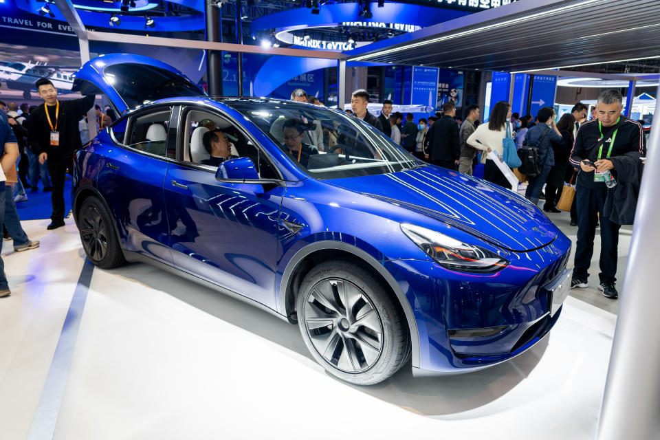 SHANGHAI, CHINA - NOVEMBER 06: People look at a Tesla Model Y SUV at the Tesla booth during the sixth China International Import Expo (CIIE) at the National Exhibition and Convention Center on November 6, 2023 in Shanghai, China. The 6th China International Import Expo kicked off on Sunday, with many cutting-edge technologies and new products making their debuts at the event. (Photo by VCG/VCG via Getty Images)