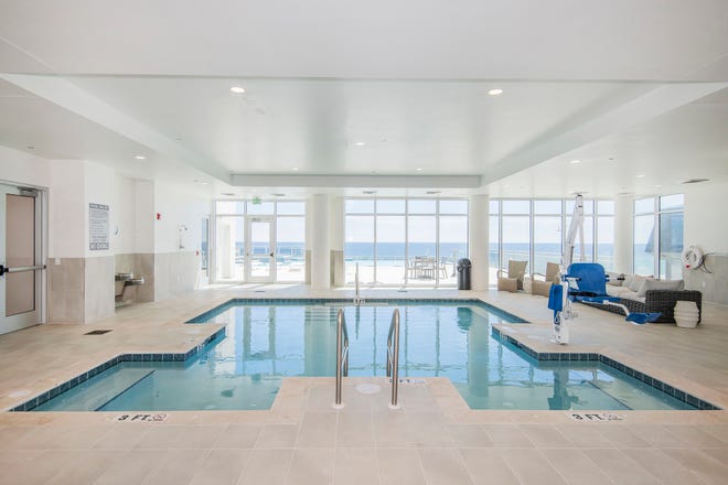A heated, indoor pool is perfect throughout the year, opens to the infinity pool deck, and overlooks the Gulf.