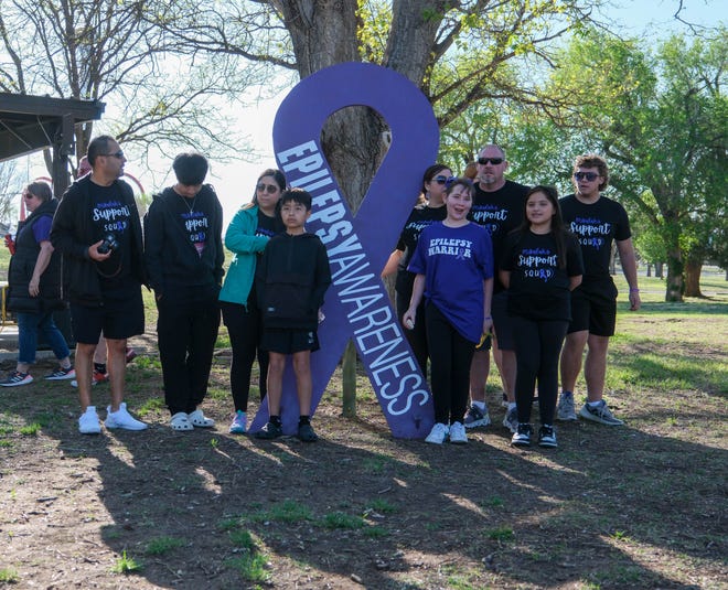 A family gathers for pictures at the Annual Epilepsy Foundation Walk Saturday at Thompson Park in Amarillo.