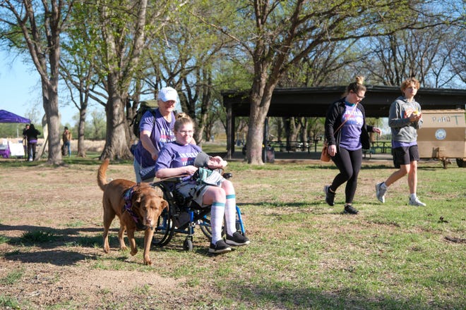 A family and their dog participate in the Annual Epilepsy Foundation Walk Saturday at Thompson Park in Amarillo.