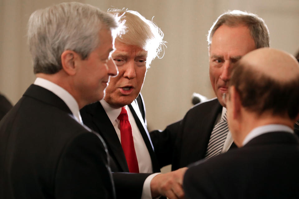 WASHINGTON, DC - FEBRUARY 03:  U.S. President Donald Trump (2nd L) greets JPMorgan Chase CEO Jamie Dimon (L) and other guests at the beginning of a policy forum in the State Dining Room at the White House February 3, 2017 in Washington, DC. Leaders from the automotive and manufacturing industries, the financial and retail services and other powerful global businesses were invited to the meeting with Trump, his advisors and family.  (Photo by Chip Somodevilla/Getty Images)