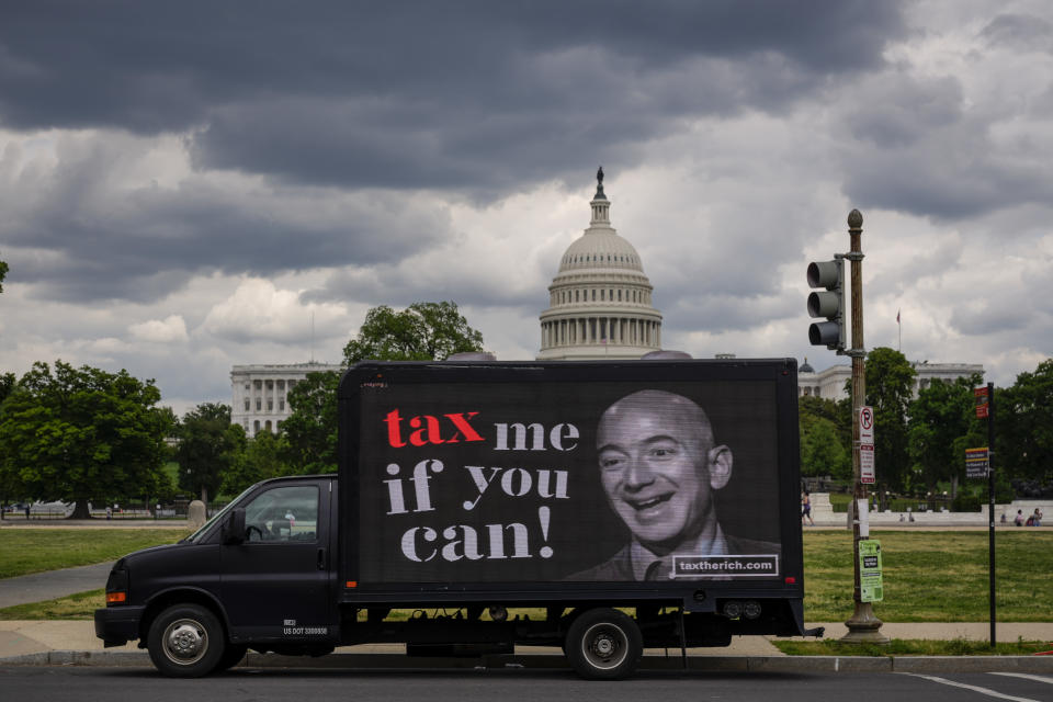 WASHINGTON, DC - MAY 17: A mobile billboard calling for higher taxes on the ultra-wealthy depicts an image of billionaire businessman Jeff Bezos, near the U.S. Capitol on May 17, 2021 in Washington, DC. Organized by the group 