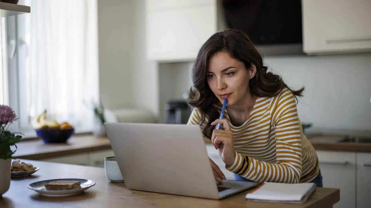 Young woman using a laptop while working from home.
