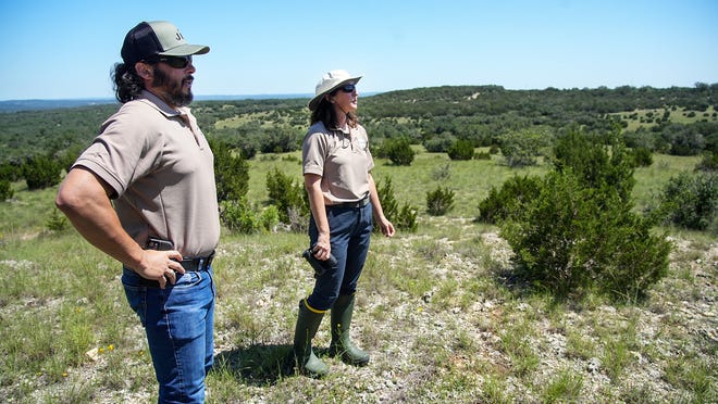 During a walk on the Castletop property on Tuesday, May 14, 2024, April Rose, Land Stewardship Manager, and Criag Bowen, Senior Land Stewardship Specialist observes the grounds. Travis County recently purchased the Castletop property for $40 million by using funds from the parks bond approved by voters last year. In lieu of housing, the property will be converted into parkland adjacent to Milton Reimers Ranch Park.