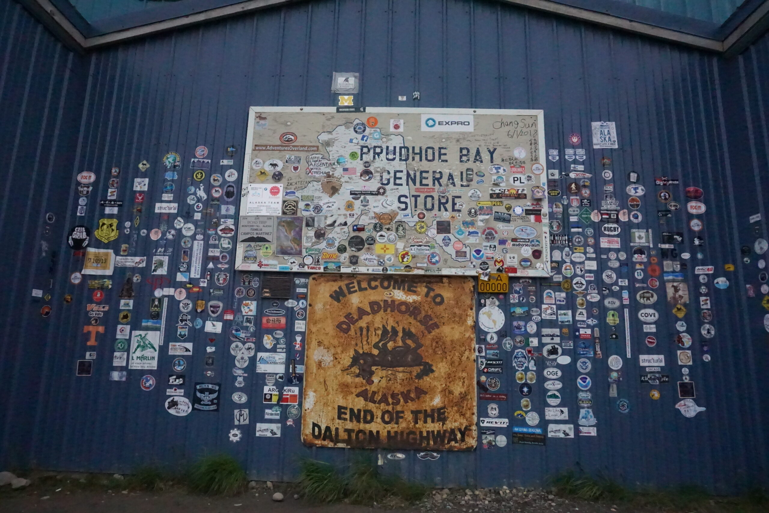 The sticker-covered exterior of the Prudhoe Bay General Store is seen on Aug. 22, 2018. (Photo by Yereth Rosen/Alaska Beacon)