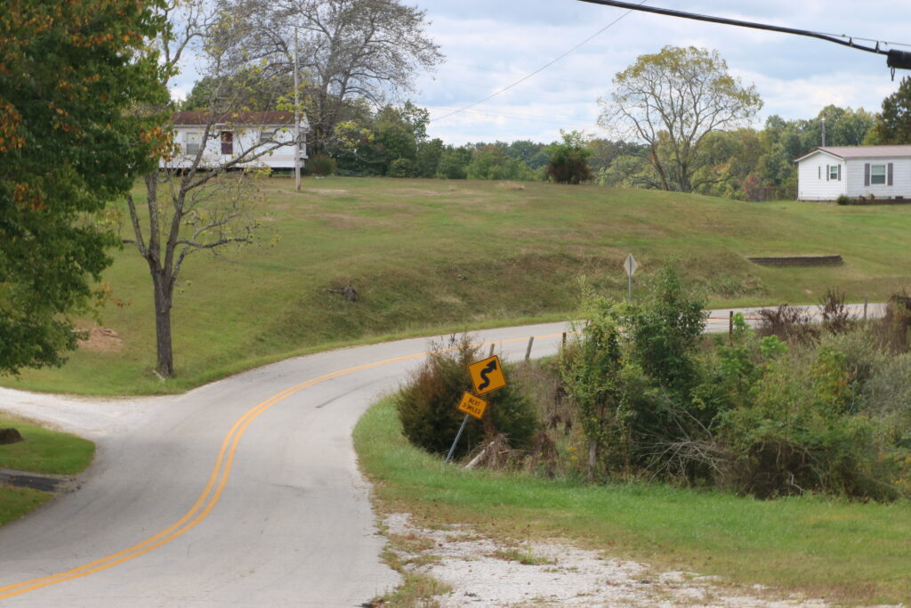 A road near the Wolfe-Lee county line curves ahead.