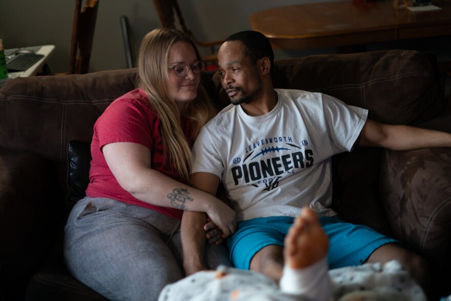 Jacob Gooch Sr. and Emily Tavis sit in their living room in Leavenworth, Kansas, three days after they were both injured by bullets at the shooting at the Kansas City Chiefs Super Bowl parade in February. Gooch’s son was also shot.