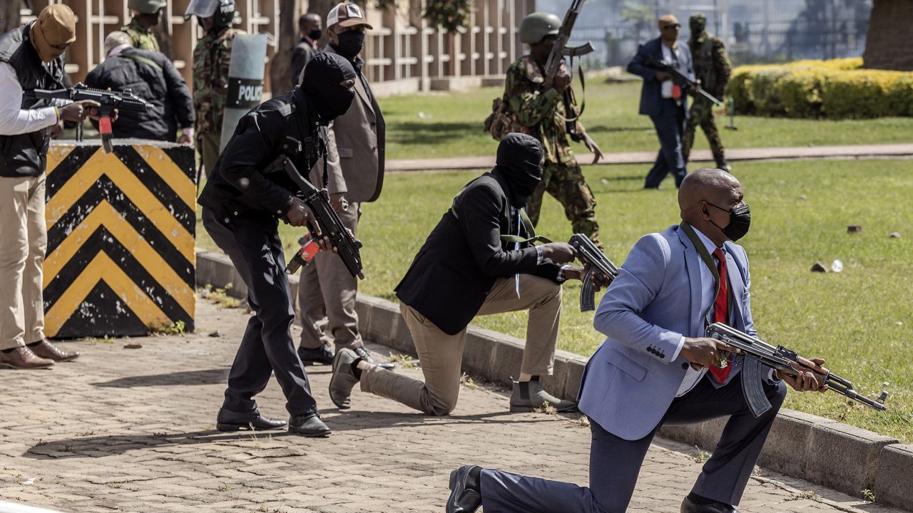 Kenyan police officers and security personnel take position to protect the Kenyan Parliament as protesters try to storm the building in downtown Nairobi, Kenya, on June 25.