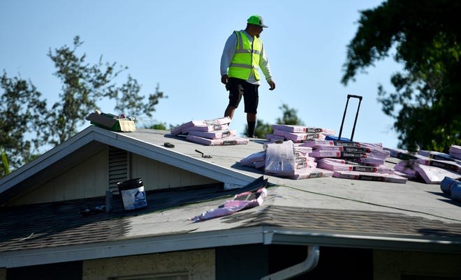 Tony Ochoa, a supervisor for Strong Roofing, checks on the progress of a roof replacement at a home in Sarasota Springs recently.