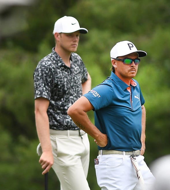 Cam Davis and Rickie Fowler look over the green on the eighth hole during the second round of the Rocket Mortgage Classic.