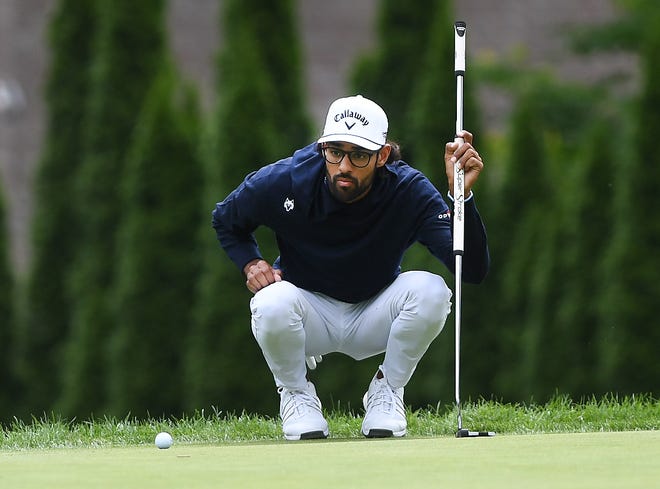 Akshay Bhatia looks over his putts on the second hole during the second round of the Rocket Mortgage Classic.