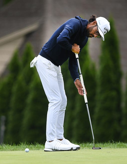 Akshay Bhatia putts on the second hole during the second round of the Rocket Mortgage Classic.