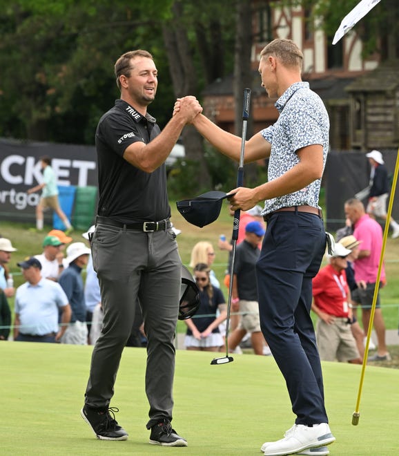 Taylor Montgomery and Matti Schmid shake hands after finishing the second round on the 18th green during the Rocket Mortgage Classic.