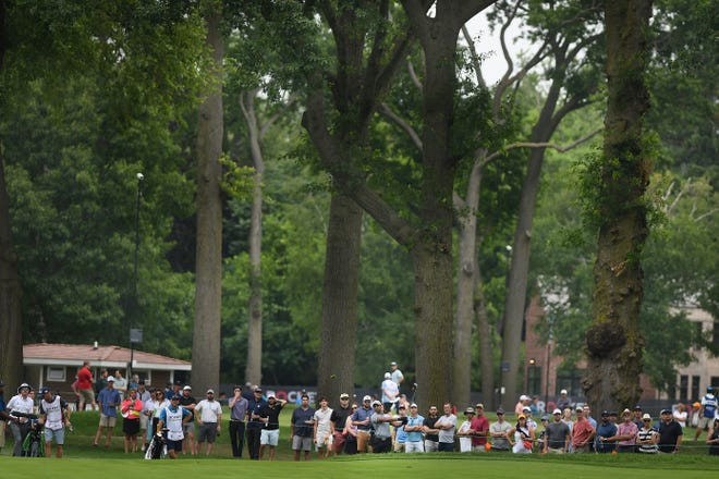 The crowd gathers along the fairway at the seventh hole during the second round of the Rocket Mortgage Classic.