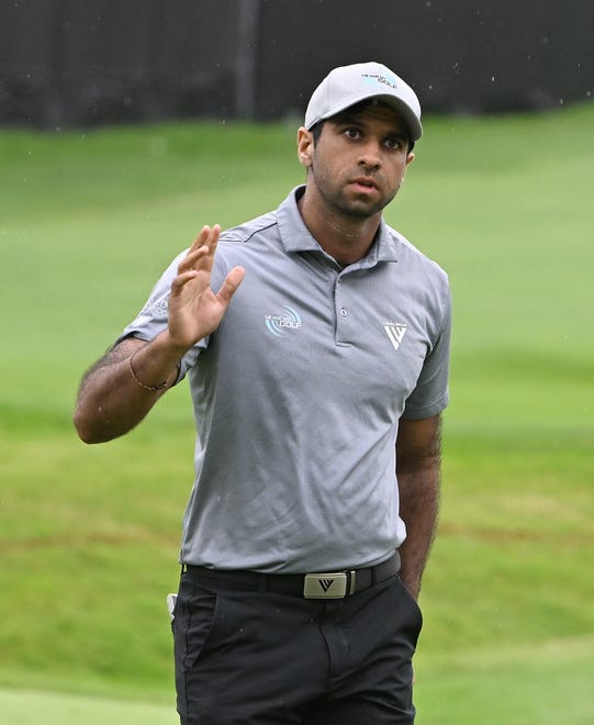 Aaron Rai acknowledges the applause after sinking his putt on 18th hole to tie the second-round lead at 13 under with Akshay Bhatia.