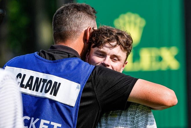 Luke Clanton hugs his caddie after finishing No. 18 during Round 3 of Rocket Mortgage Classic at Detroit Golf Club in Detroit on Saturday, June 29, 2024.