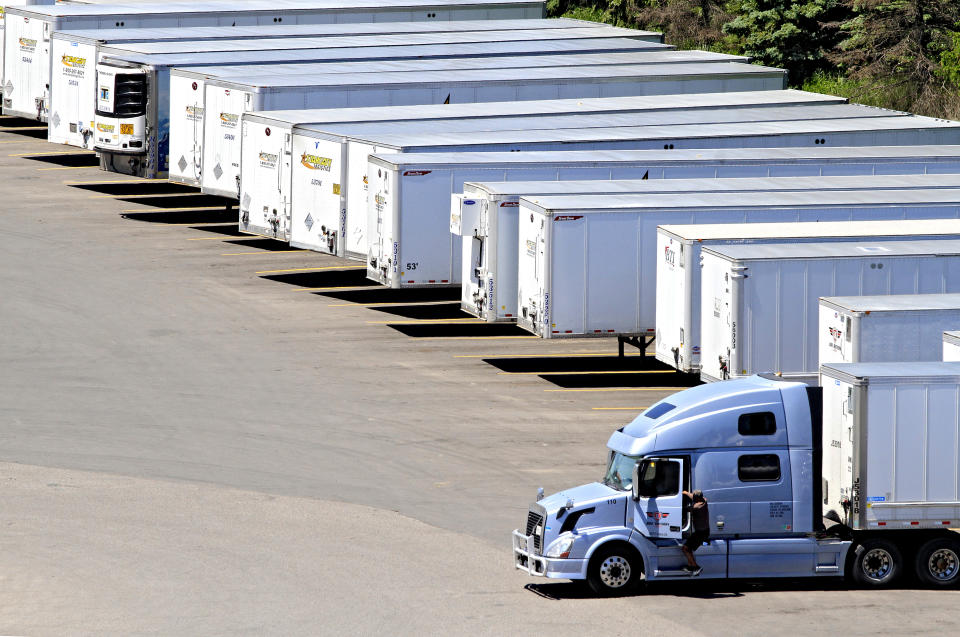 A driver is climbing into a transport truck in a parking lot full of trailers near Highway 410 in Mississauga, Ontario, on May 31, 2024. (Photo by Mike Campbell/NurPhoto via Getty Images)