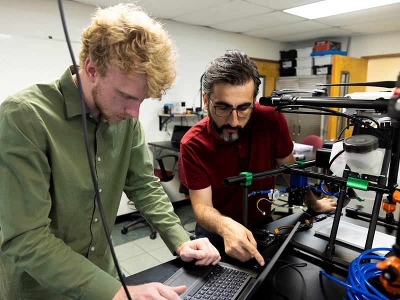 Mechanical engineering master's student Justin Dykstra, left, works with Cengiz Koparan, assistant professor of precision agriculture technology in the Agricultural Education, Communications and Technology Department. Koparan is one of 10 U of A System faculty members recently awarded $25,000 in the first Engineering Applications in Agriculture seed funding program.