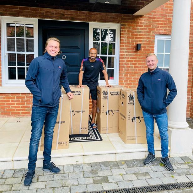 Dean Franklin and Alex Scott with a customer